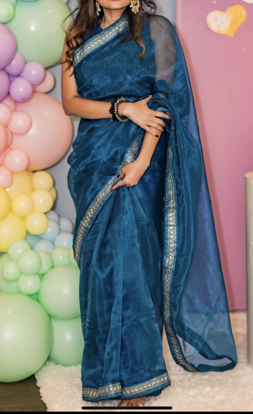 Picture of Beautiful peacock blue organza saree with sleeves blouse