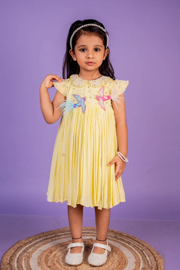 Picture of lemon yellow pearl frock 2-3y