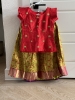 Picture of Ruby red with Olive green lehenga which has red floral motifs